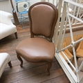 Louis XV occasional chair covered in leather with studs.