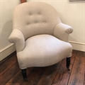 Small French vintage tub chair covered in Taupe linen with black turned legs and original castors. Late 19thC